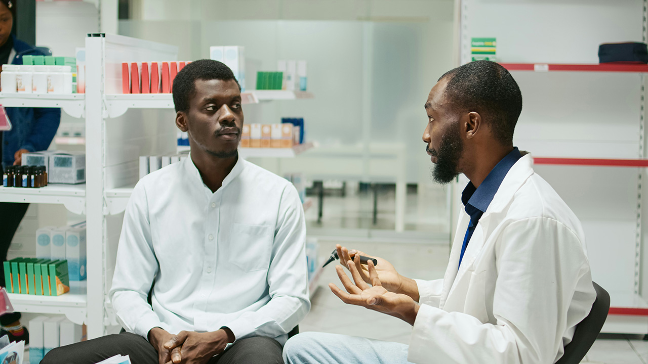 Medical provider in a discussion with another man.
